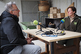 Tierpfleger mit Journalist sitzend im Gespräch